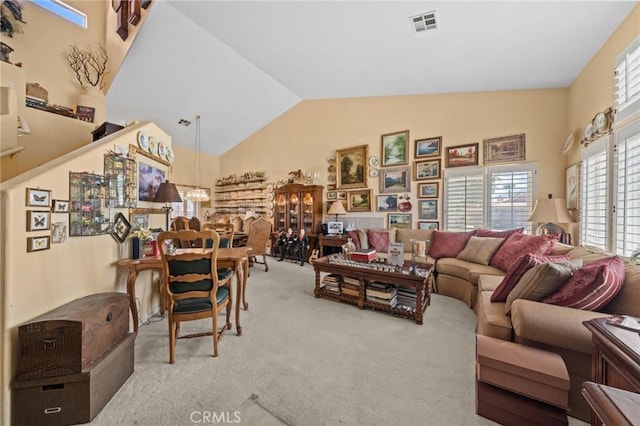 living room featuring lofted ceiling and light colored carpet