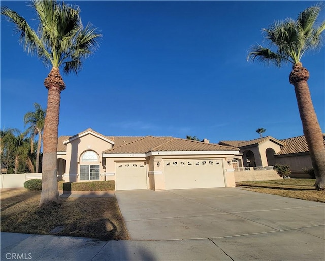 mediterranean / spanish-style home with a garage