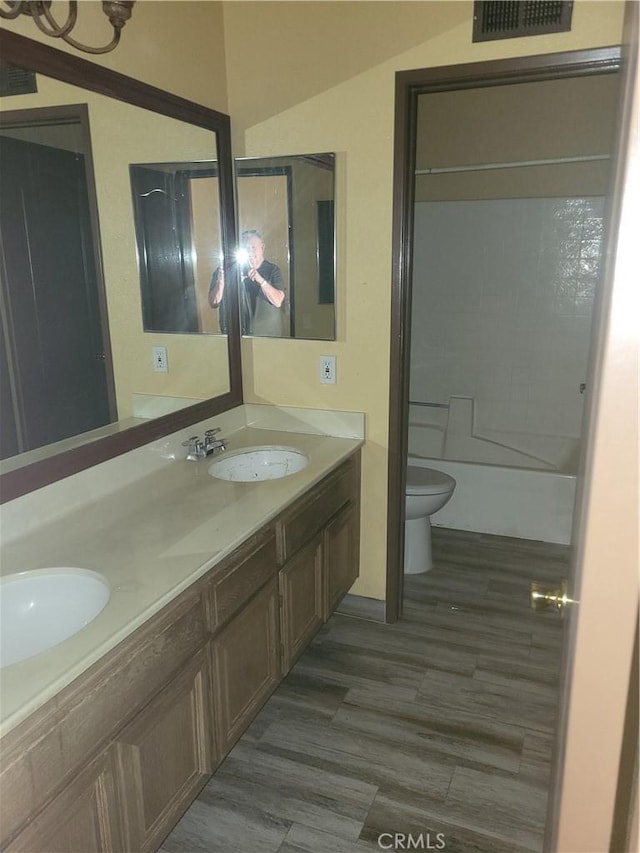 bathroom featuring hardwood / wood-style flooring, toilet, and vanity