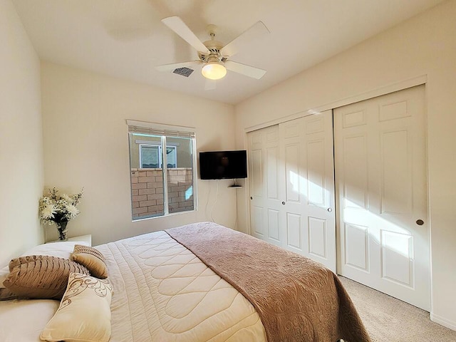 bedroom featuring ceiling fan, a closet, and carpet floors