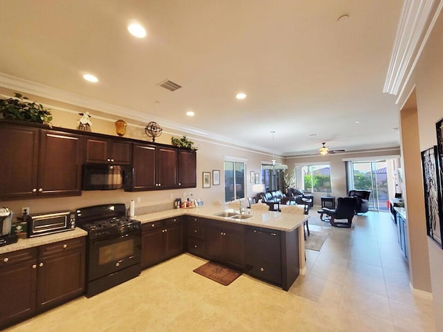 kitchen featuring black appliances, kitchen peninsula, sink, crown molding, and hanging light fixtures