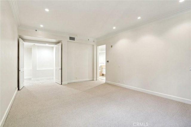 unfurnished room featuring light colored carpet and crown molding