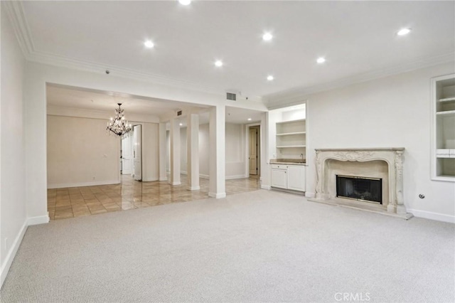 unfurnished living room with light colored carpet, a high end fireplace, crown molding, and a chandelier