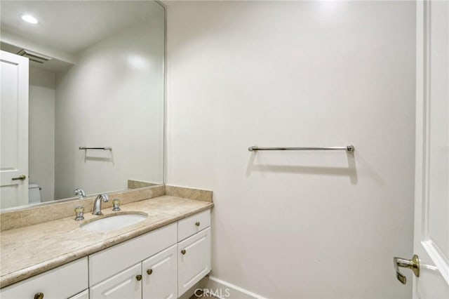 bathroom featuring toilet and vanity