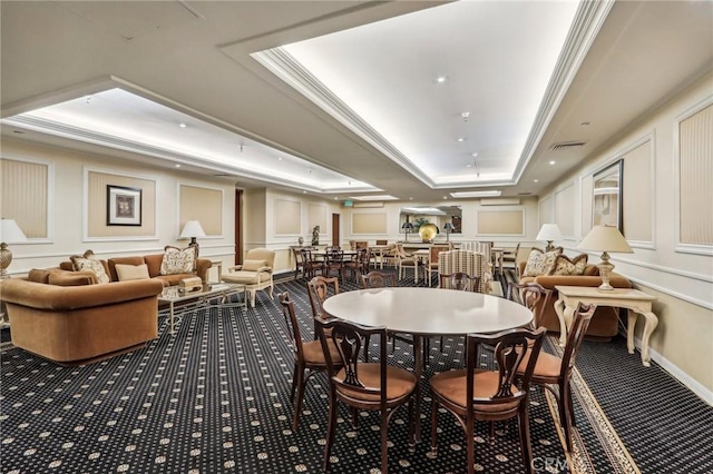 dining room with crown molding, carpet floors, and a tray ceiling