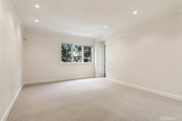 spare room featuring light carpet and crown molding