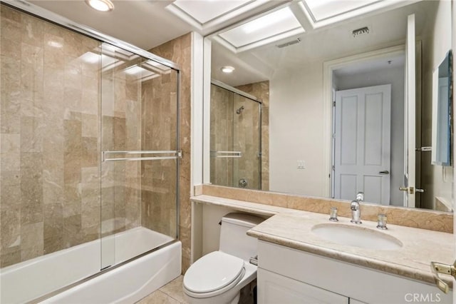 full bathroom with toilet, vanity, tile patterned flooring, and combined bath / shower with glass door