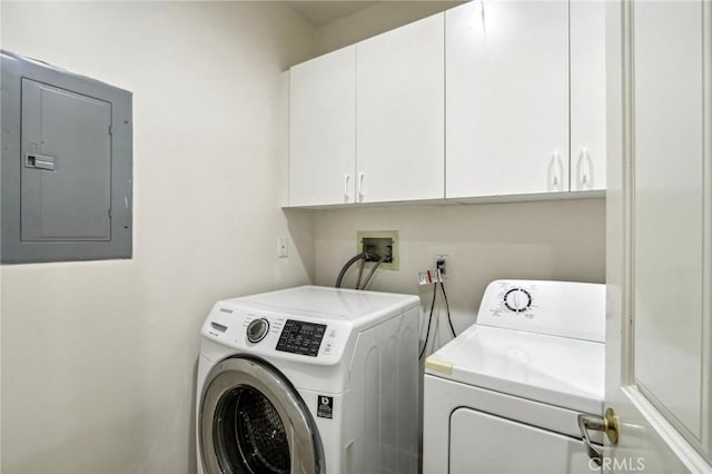 laundry room featuring cabinets, electric panel, and washer and dryer