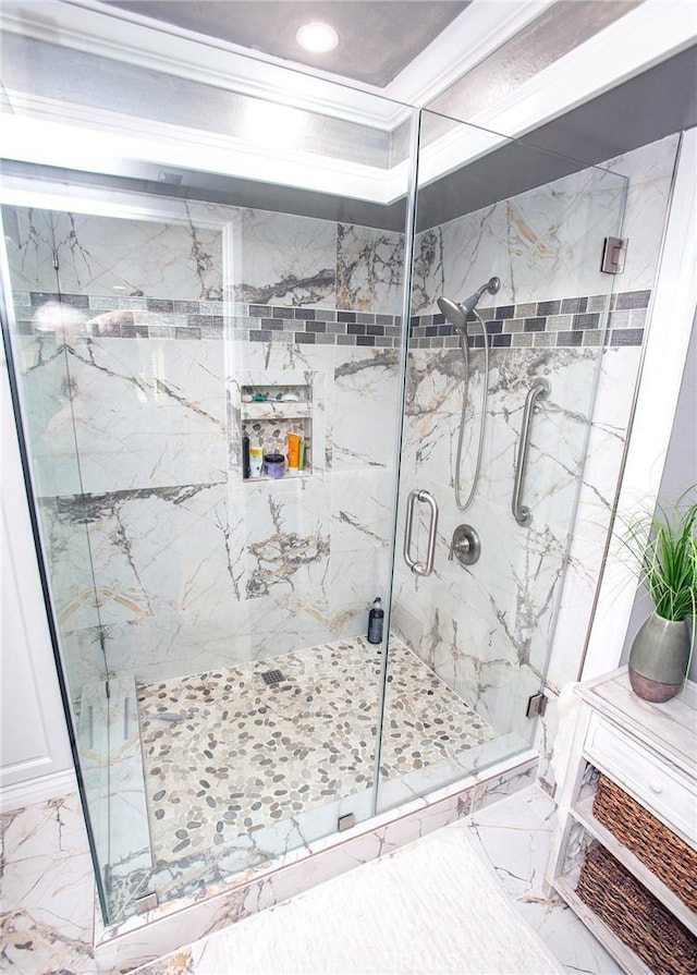 bathroom featuring an enclosed shower and crown molding