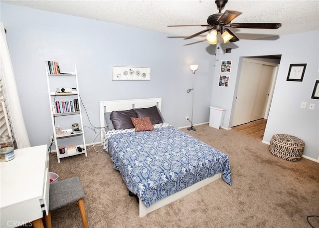 bedroom featuring ceiling fan, a textured ceiling, and carpet flooring