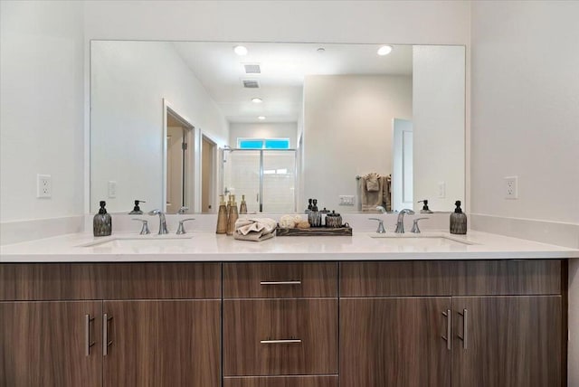 bathroom featuring walk in shower and vanity