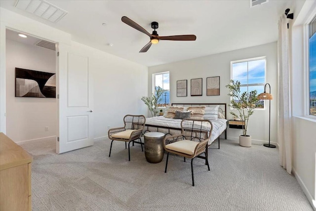 bedroom featuring light carpet and ceiling fan