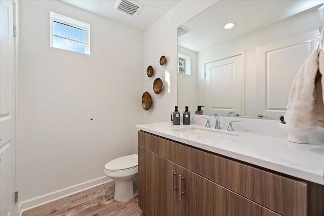 bathroom featuring hardwood / wood-style floors, toilet, and vanity