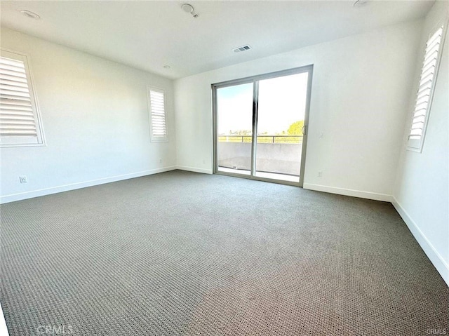 empty room with dark colored carpet