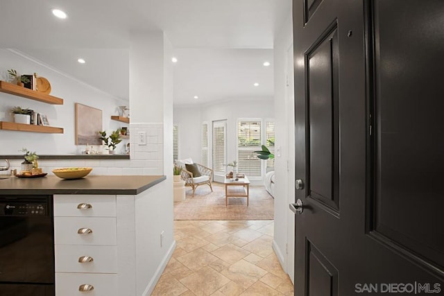 kitchen featuring white cabinets, backsplash, black dishwasher, and ornamental molding