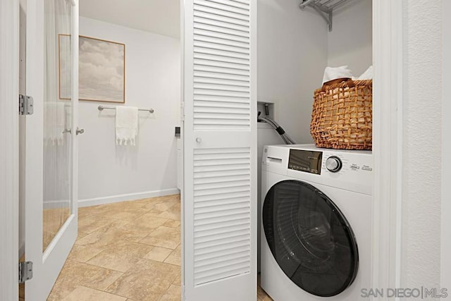 clothes washing area featuring washer / dryer