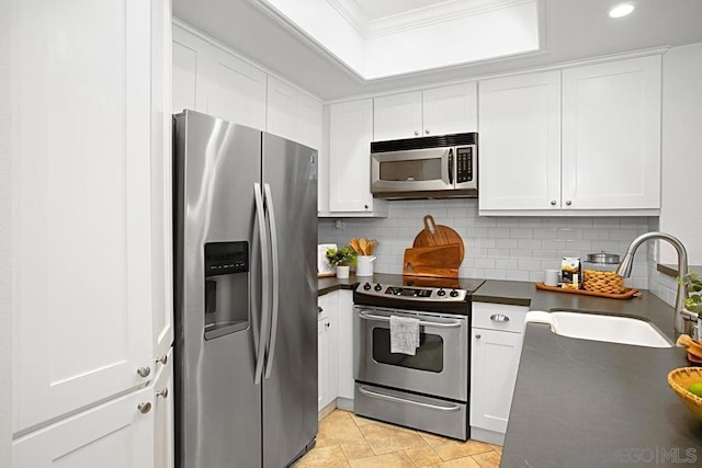 kitchen with appliances with stainless steel finishes, crown molding, white cabinetry, and sink