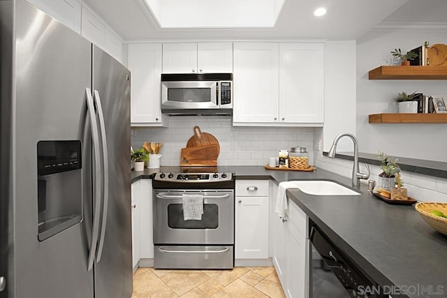 kitchen with stainless steel appliances, white cabinets, and sink