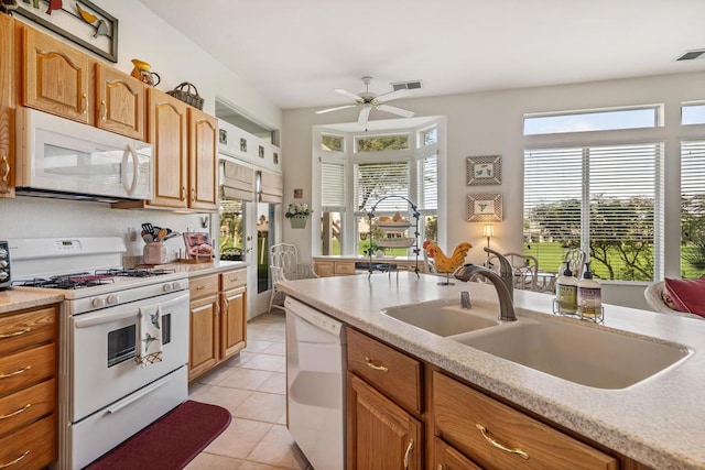 kitchen with light tile patterned floors, white appliances, ceiling fan, and sink