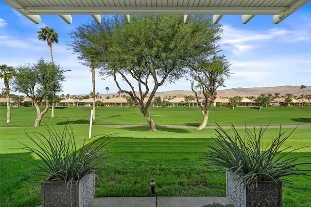 view of community featuring a mountain view and a yard