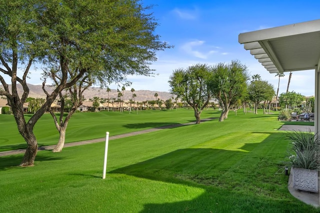 view of home's community featuring a mountain view and a lawn