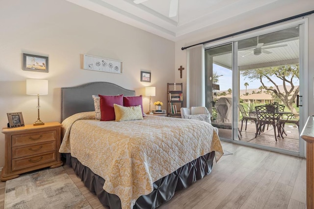 bedroom featuring ceiling fan, light hardwood / wood-style floors, and access to exterior