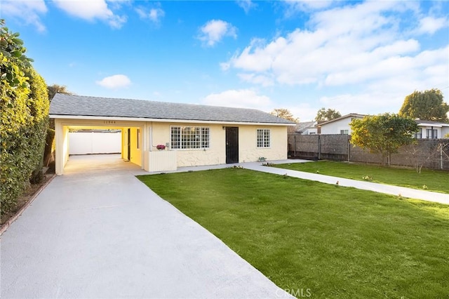 ranch-style house featuring a carport and a front yard