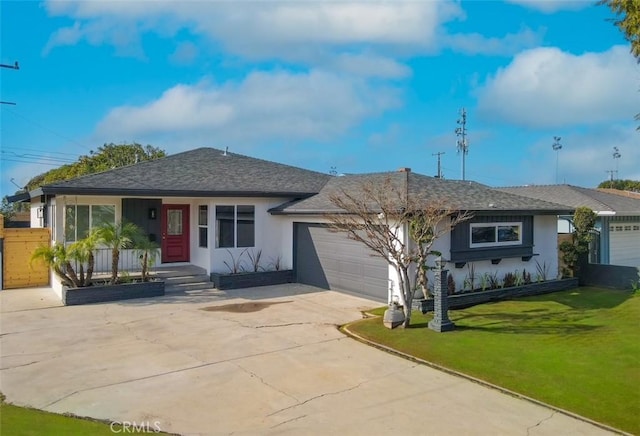 single story home featuring a garage and a front lawn