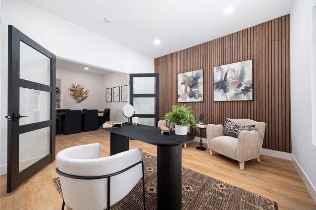 office featuring wood walls and light hardwood / wood-style floors