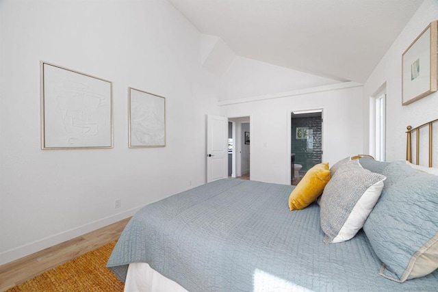 bedroom with hardwood / wood-style flooring and high vaulted ceiling