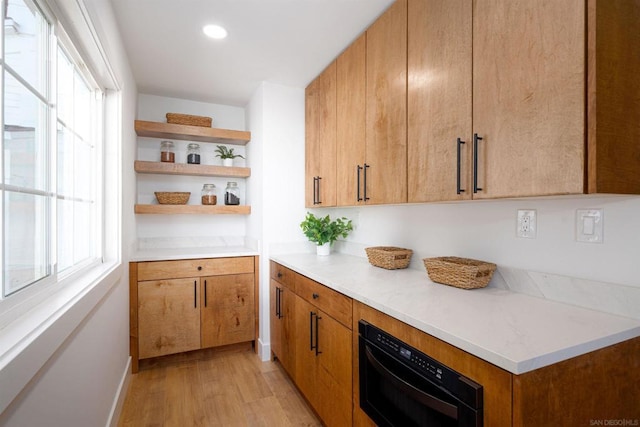 kitchen with plenty of natural light and light hardwood / wood-style flooring