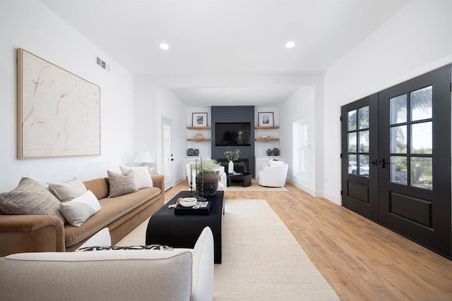 living room featuring light hardwood / wood-style floors and french doors