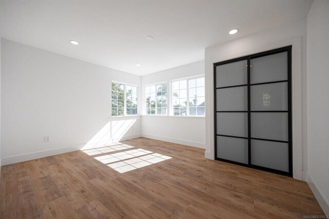 spare room with light hardwood / wood-style flooring