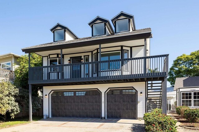 cape cod home featuring a garage