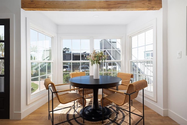 sunroom with a wealth of natural light and beamed ceiling