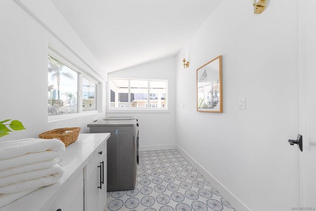 laundry area with washer / clothes dryer and cabinets