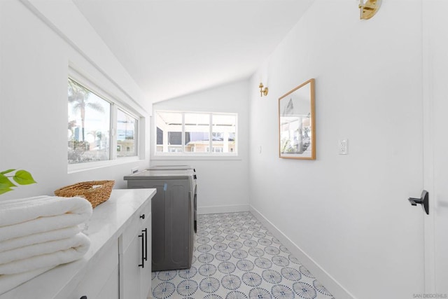 laundry room with washer / clothes dryer and cabinets