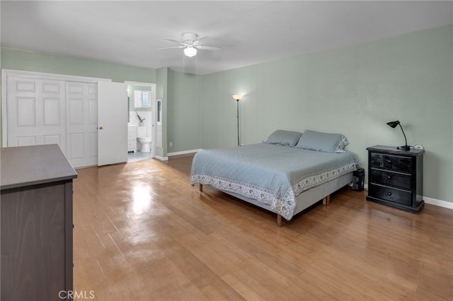 bedroom with ceiling fan, light hardwood / wood-style floors, and connected bathroom