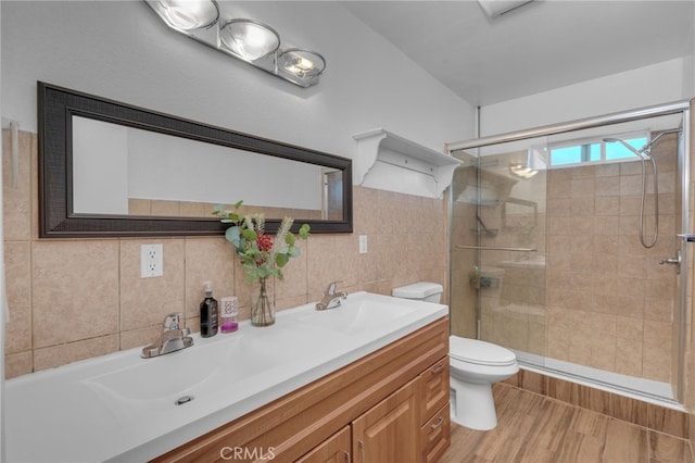 bathroom featuring an enclosed shower, wood-type flooring, vanity, decorative backsplash, and toilet