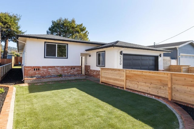 view of front of house with a garage and a front yard