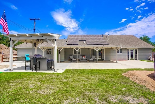 back of property featuring outdoor lounge area, exterior bar, a lawn, and a patio