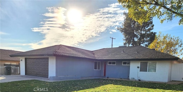 single story home featuring a garage and a front lawn