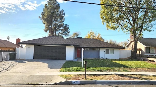 single story home featuring a front lawn and a garage