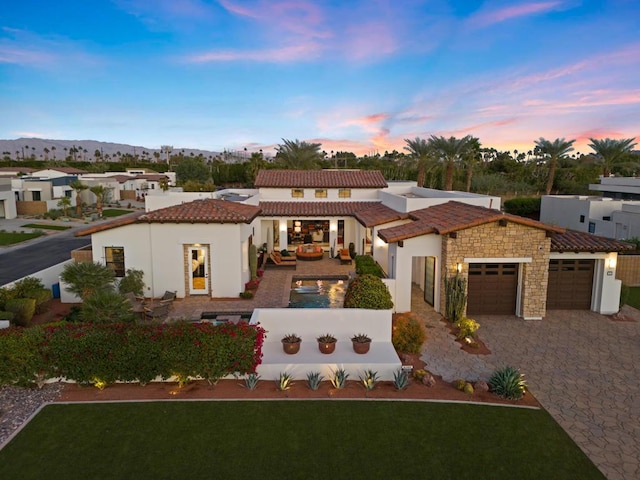 mediterranean / spanish home featuring a garage and a mountain view