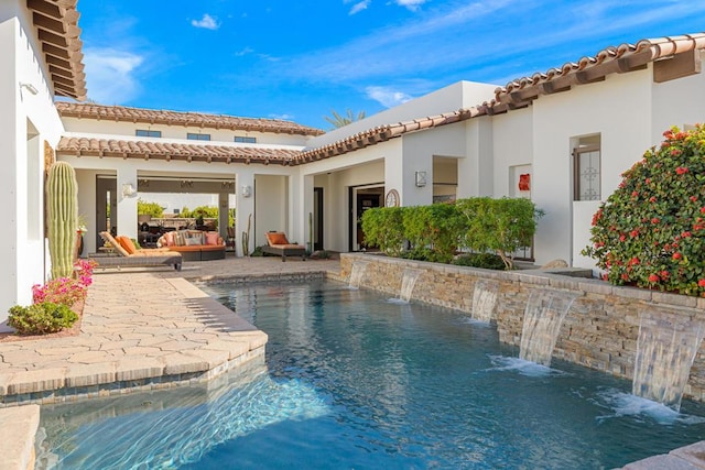 view of pool featuring pool water feature and a patio area