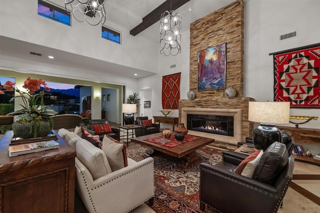 living room featuring an inviting chandelier, a fireplace, beam ceiling, and a high ceiling