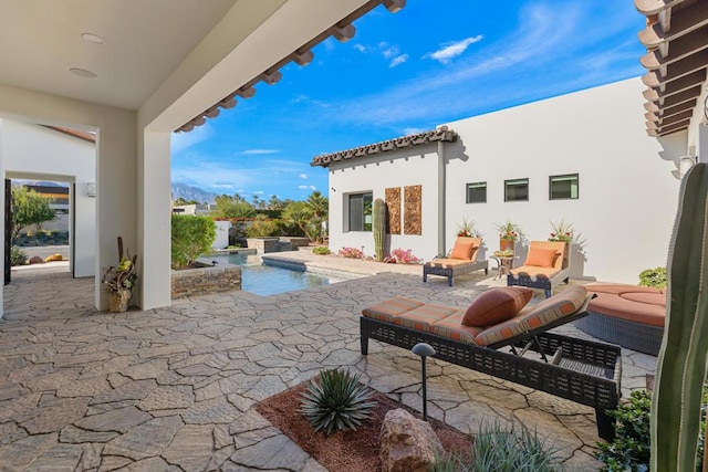 view of patio with a swimming pool with hot tub and an outdoor hangout area