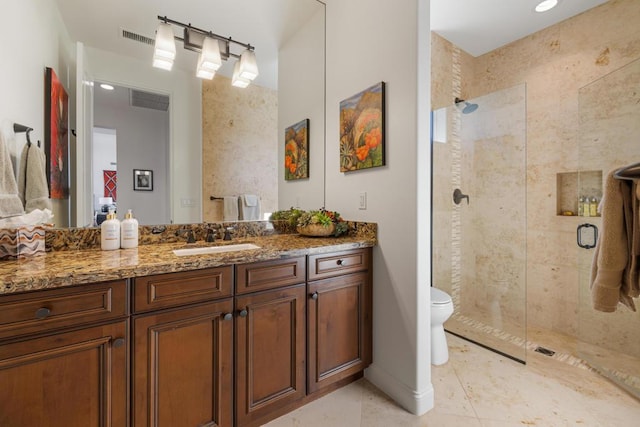 bathroom with tile patterned flooring, vanity, an enclosed shower, and toilet