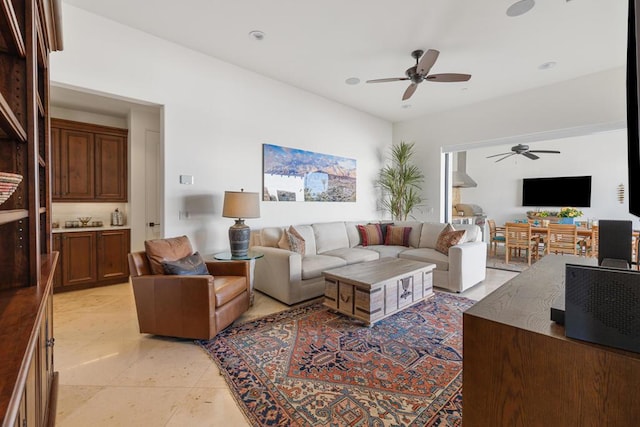 living room featuring light tile patterned floors and ceiling fan