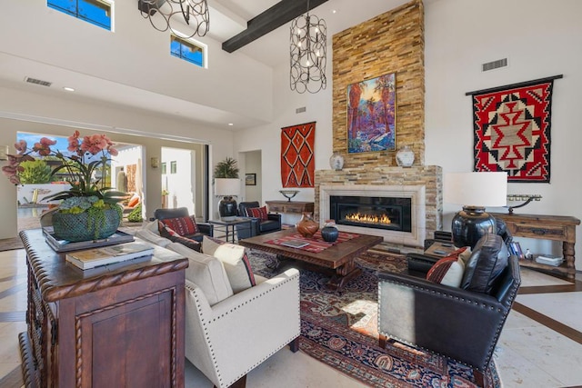 living room featuring beam ceiling, a stone fireplace, and a high ceiling